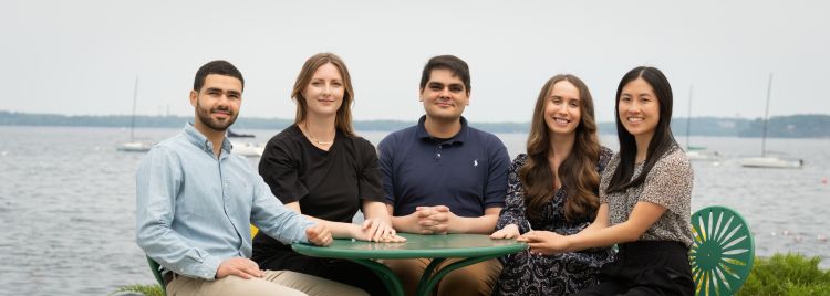 The 2025-26 chief residents sitting at a table outside.